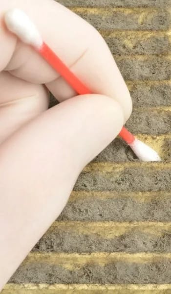 Authentic Indoor Air Quality Treatment by an Expert Air Quality Service Thumbnail - The Qualified Specialist Cleaning the Wall with a Cottonbud